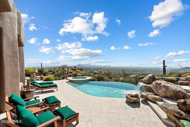 view of swimming pool with an in ground hot tub, pool water feature, a mountain view, and a patio