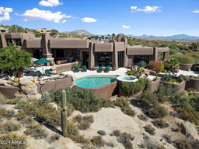 view of swimming pool with a mountain view and a patio area