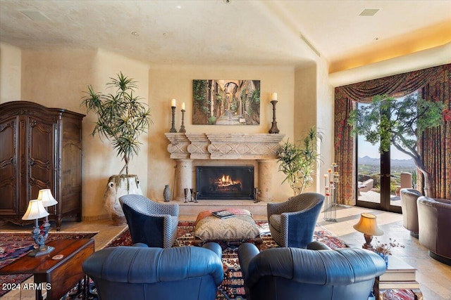 living area featuring french doors and a fireplace