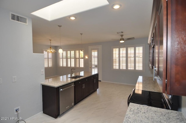 kitchen featuring sink, plenty of natural light, stainless steel dishwasher, hanging light fixtures, and black range