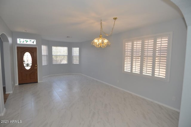 foyer featuring a chandelier