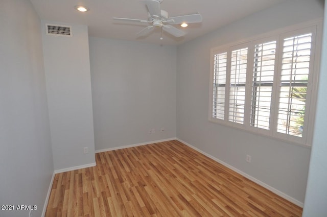 spare room featuring light hardwood / wood-style floors and ceiling fan