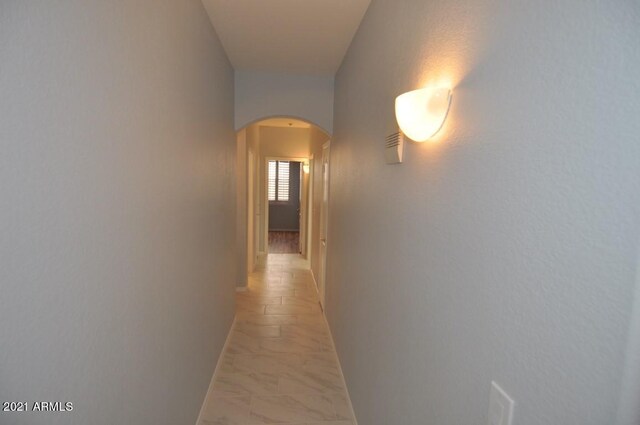 18071 W Douglas Way, Surprise, AZ 85374 - hallway with arched walkways and light marble finish floors