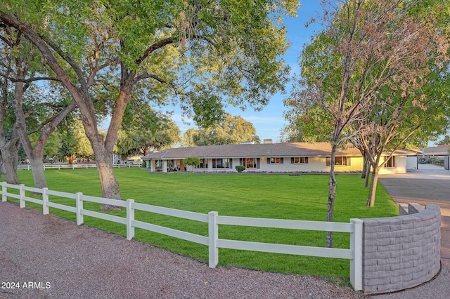 single story home with a front yard and a garage