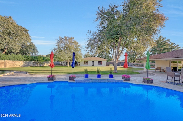 view of swimming pool with a lawn and a patio