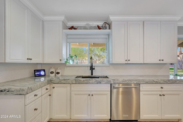 kitchen featuring white cabinetry, sink, decorative backsplash, and ornamental molding