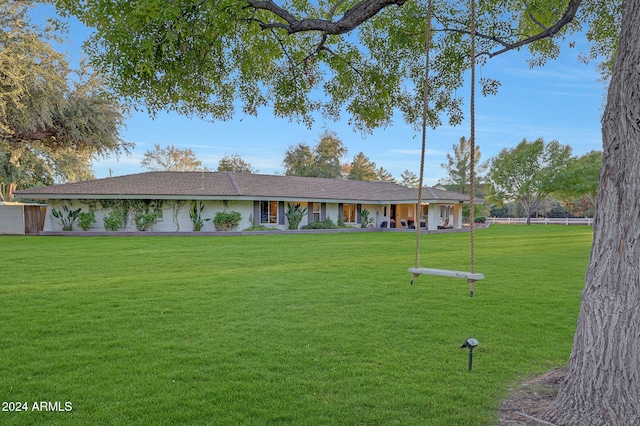 single story home featuring a front lawn