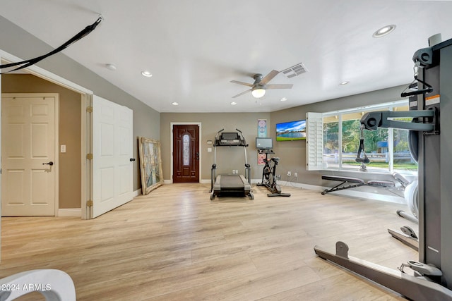 workout room with ceiling fan and light hardwood / wood-style flooring