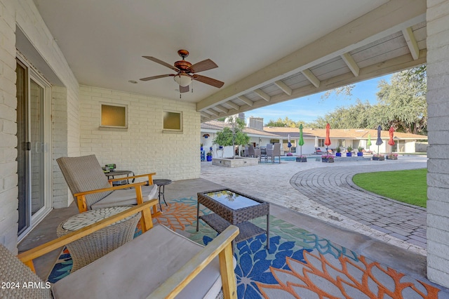 view of patio with an outdoor living space and ceiling fan