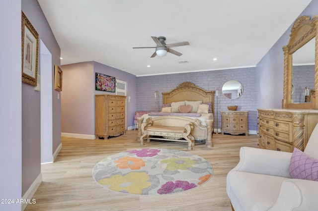 bedroom featuring light wood-type flooring, brick wall, and ceiling fan