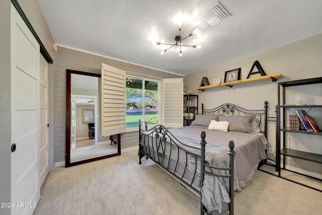 carpeted bedroom featuring an inviting chandelier and a closet