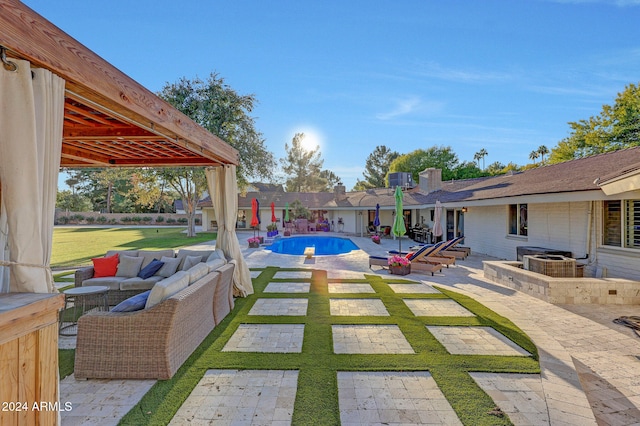 view of patio / terrace with a fenced in pool, an outdoor living space, and a gazebo