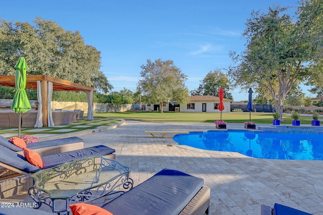 view of pool with a lawn, outdoor lounge area, and a patio