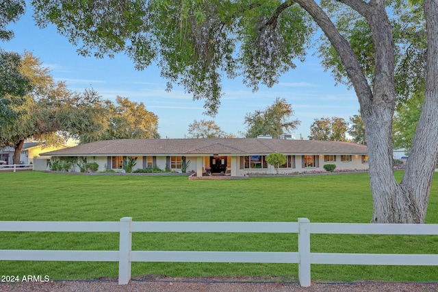 ranch-style home featuring a front yard