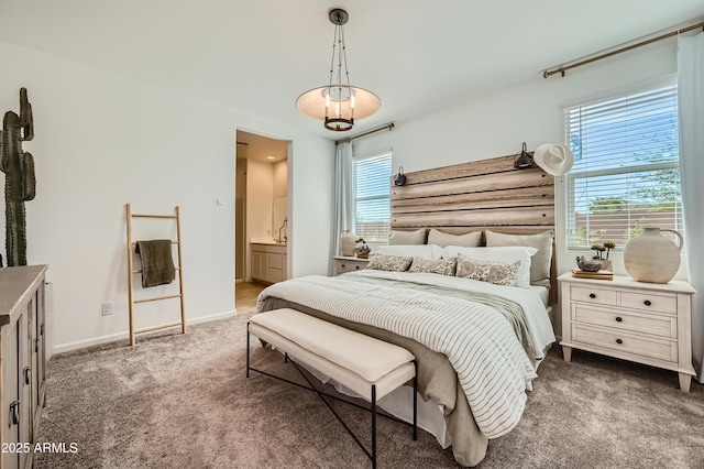 carpeted bedroom featuring ensuite bath