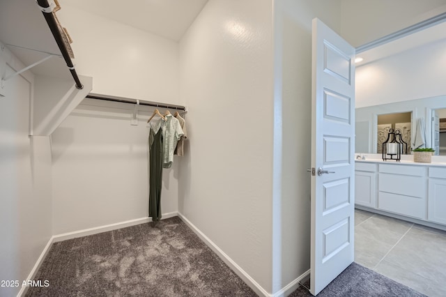 walk in closet featuring light carpet