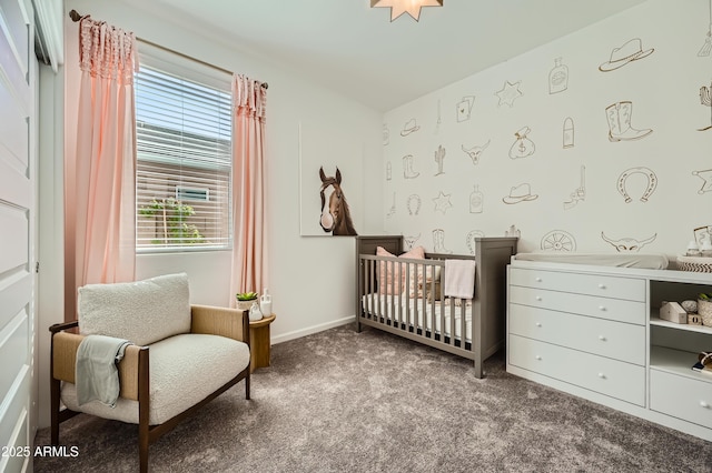 bedroom featuring a nursery area and carpet floors