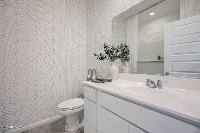 bathroom with tile patterned flooring, vanity, and toilet