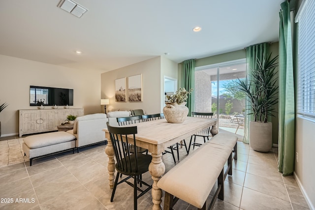 tiled dining area featuring plenty of natural light