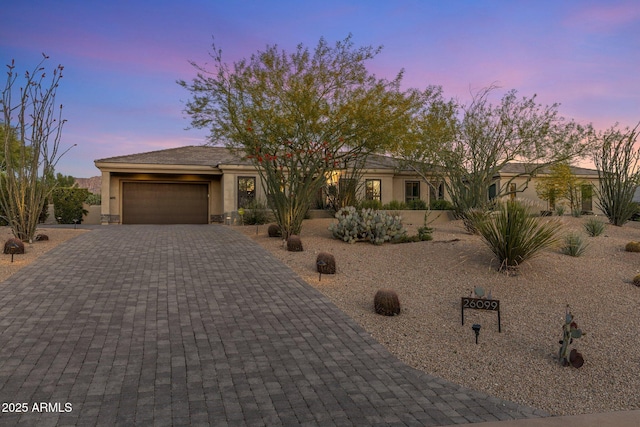 26099 N 88th Way, Scottsdale, AZ 85255 - view of front of home with stucco siding, decorative driveway, and an attached garage