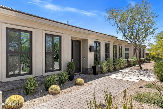 26099 N 88th Way, Scottsdale, AZ 85255 - rear view of house featuring a patio area, stucco siding, and stone siding