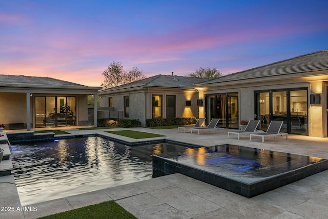 26099 N 88th Way, Scottsdale, AZ 85255 - pool at dusk featuring a patio area, an in ground hot tub, and an outdoor pool