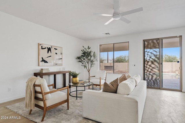 living room with ceiling fan and light wood-type flooring