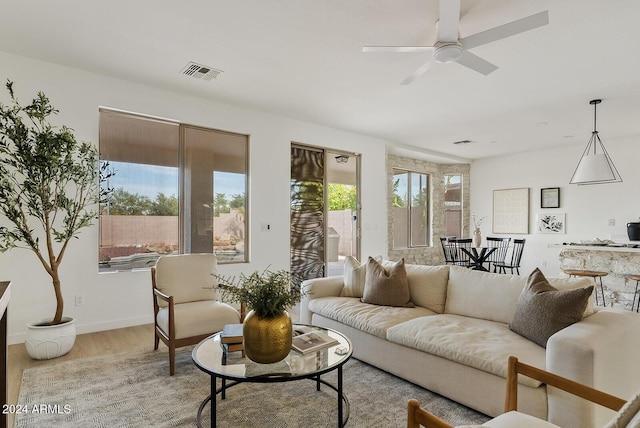 living room featuring light hardwood / wood-style floors and ceiling fan