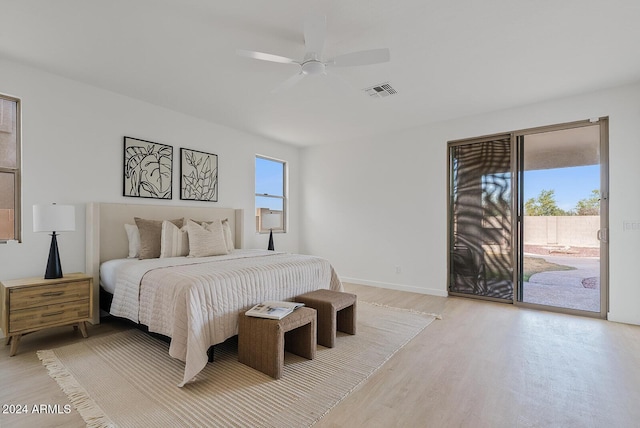 bedroom with ceiling fan, access to exterior, and light hardwood / wood-style flooring