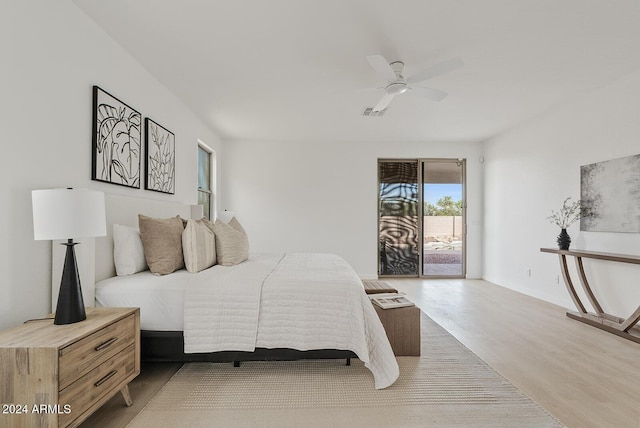 bedroom with hardwood / wood-style floors, ceiling fan, and access to exterior