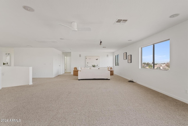 unfurnished bedroom with light colored carpet and ceiling fan