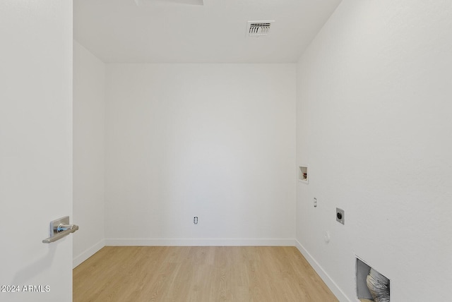 laundry area featuring electric dryer hookup, hookup for a washing machine, and light hardwood / wood-style floors