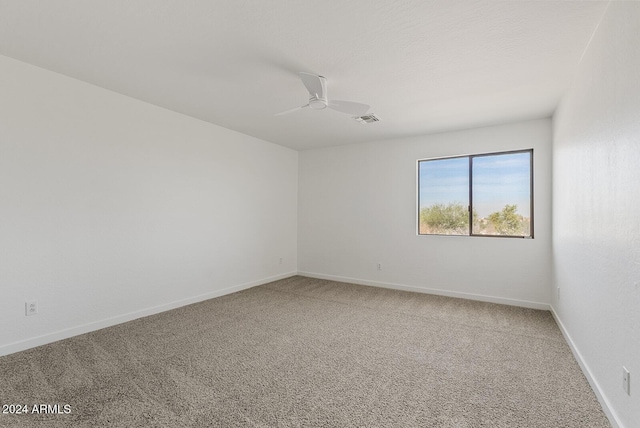 spare room with carpet floors and ceiling fan