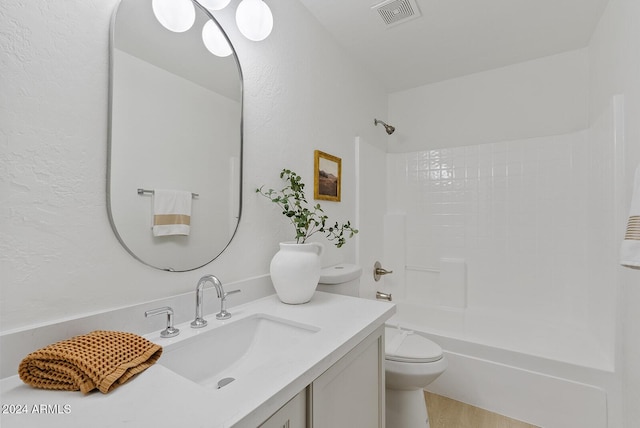 full bathroom featuring hardwood / wood-style floors, vanity, toilet, and washtub / shower combination