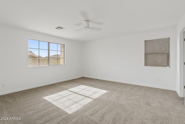 unfurnished room featuring light carpet and ceiling fan