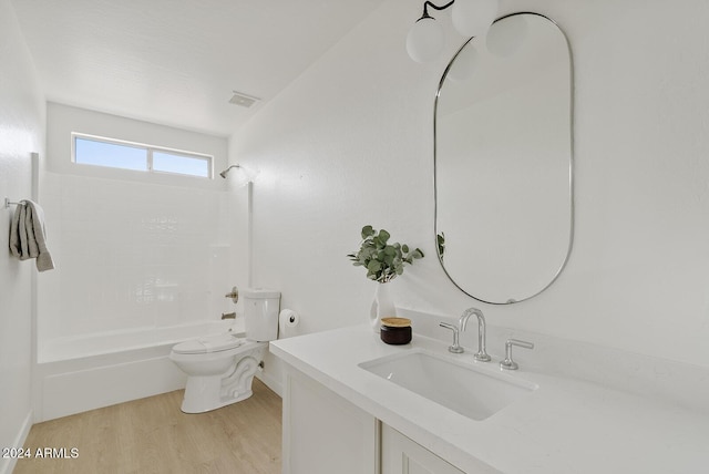 full bathroom with washtub / shower combination, wood-type flooring, vanity, and toilet