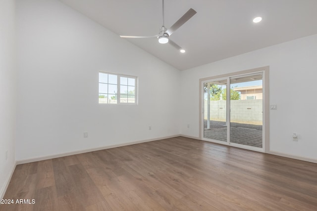 spare room with wood-type flooring, high vaulted ceiling, and ceiling fan