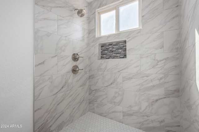 bathroom with a tile shower