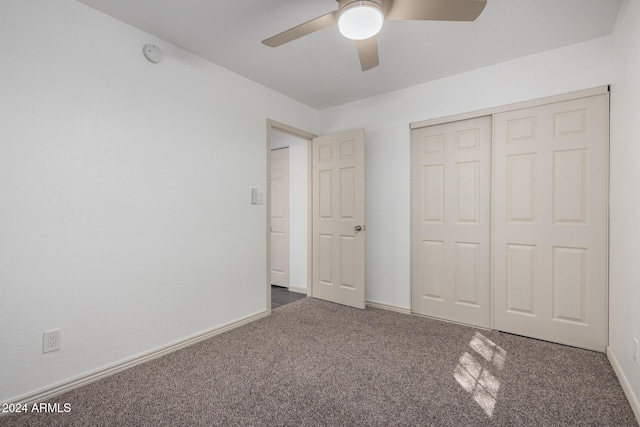 unfurnished bedroom featuring a closet, ceiling fan, and dark carpet