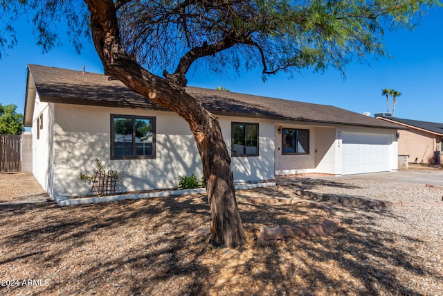 ranch-style home featuring a garage