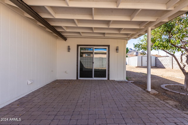 view of patio featuring a storage unit