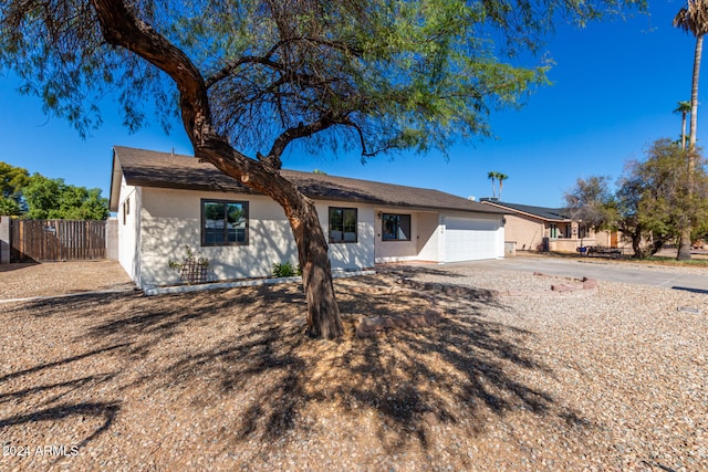 ranch-style home featuring a garage