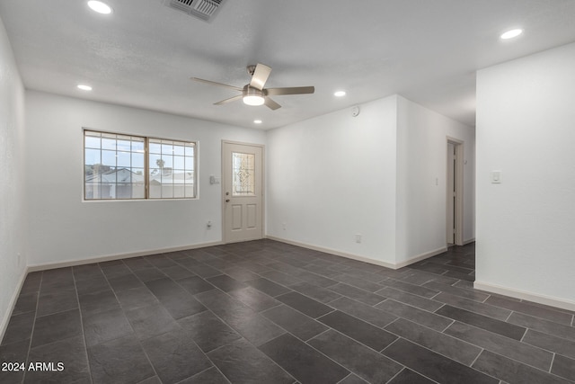 empty room with ceiling fan and dark hardwood / wood-style flooring