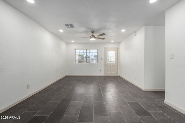 unfurnished room with ceiling fan