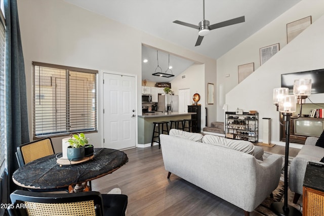 living room with high vaulted ceiling, dark hardwood / wood-style floors, and ceiling fan