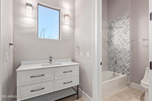 full bathroom featuring tile patterned flooring, vanity, tiled shower / bath combo, and toilet