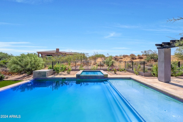 view of swimming pool with an in ground hot tub