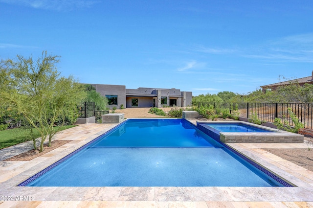 view of pool with a patio and an in ground hot tub