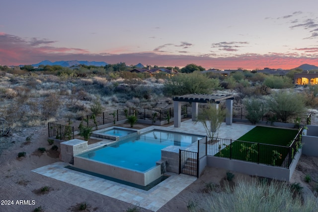 pool at dusk with a pergola, an in ground hot tub, and a patio area