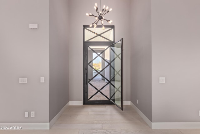 foyer featuring a chandelier and light hardwood / wood-style flooring